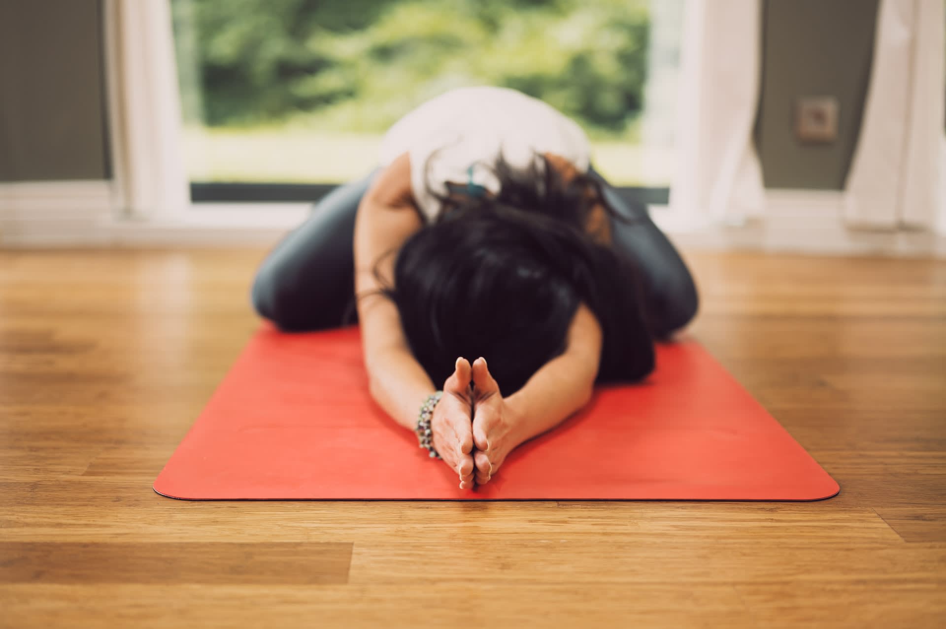 Female Pilates student stretching